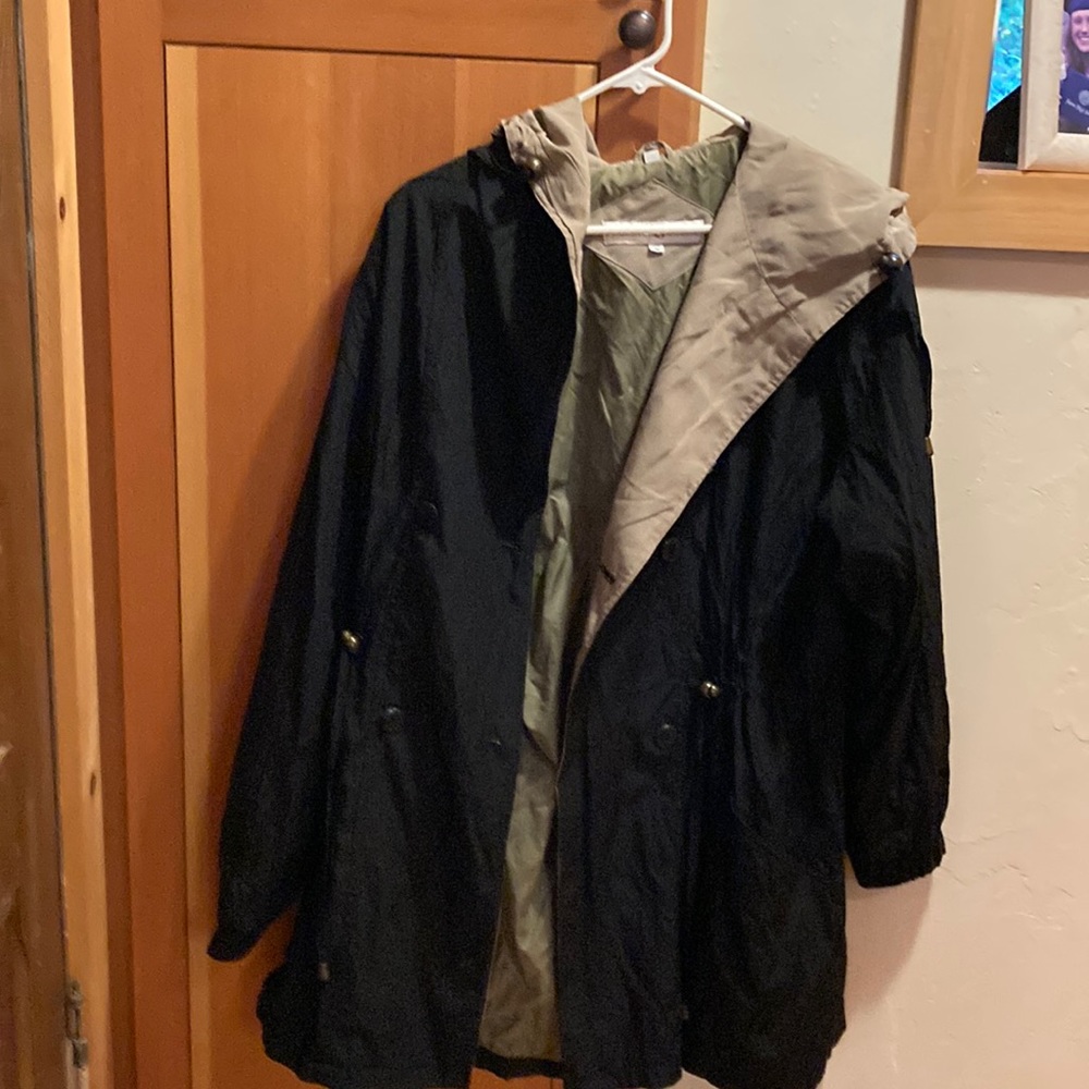 Stylish black rain coat with a hood and cute drapery in the back